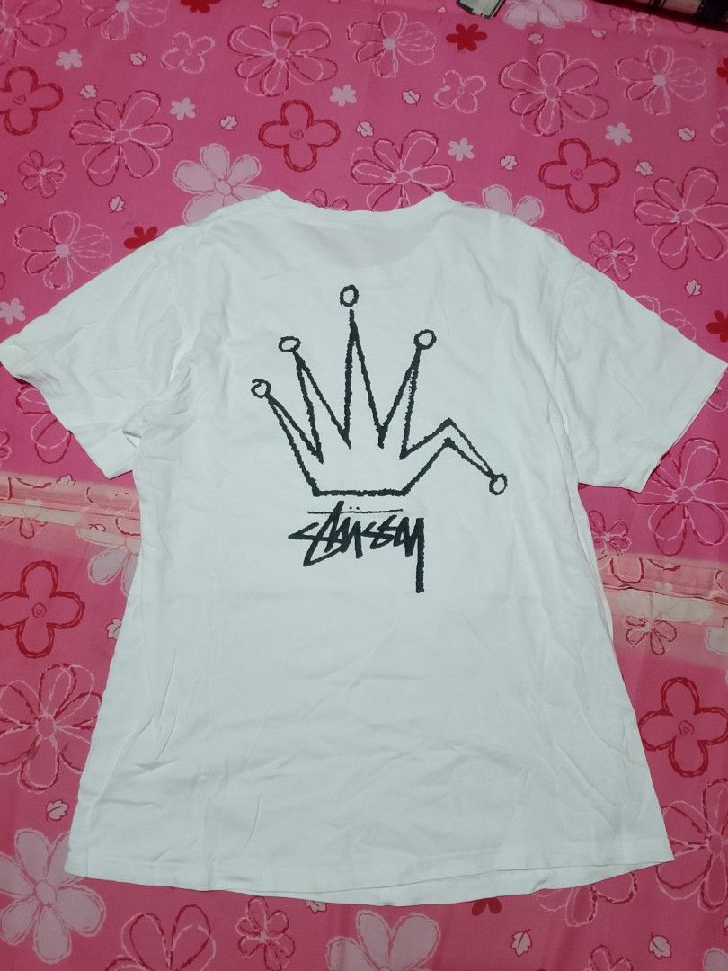Stüssy Crown Logo White Tee (Category: Tshirts & Polo Shirts ) located in Iloilo. Submitted by janillthrifted (Listing ID 1465313567, Image 3). Description: - Authentic Stüssy white t-shirt - Small crown logo on front chest - Large bold crown graphic and classic signature on the back - Soft and breathable 100% cotton material - Standard fit with short sleeves and crew neck - Versatile streetwear piece, easy to pair with jeans or shorts.