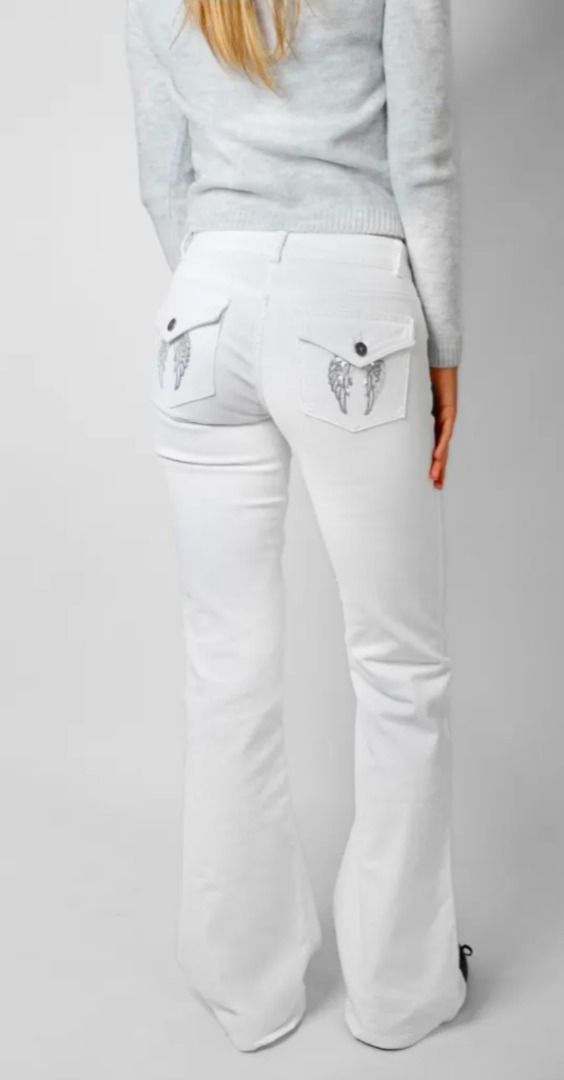 Subdued Low-waist flared jeans with pockets with wings (Category: Jeans) located in Manila. Submitted by kc.kc5 (Listing ID 1465282269, Image 1). Description: - Style: Y2K low-rise flare jeans - Fit: Slim through hips and thighs with a flared leg - Details: Unique back pocket flaps with silver embroidered angel wings and button closures - Material: Soft cotton blend with slight stretch for comfort - Closure: Standard front button fly with belt lo
