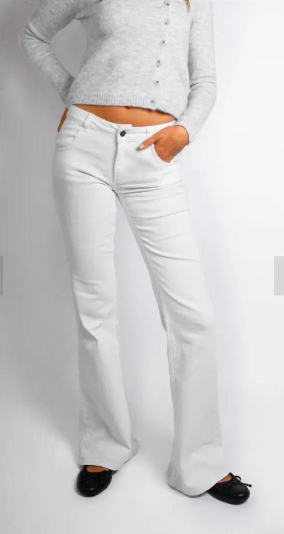 Subdued Low-waist flared jeans with pockets with wings (Category: Jeans) located in Manila. Submitted by kc.kc5 (Listing ID 1465282269, Image 2). Description: - Style: Y2K low-rise flare jeans - Fit: Slim through hips and thighs with a flared leg - Details: Unique back pocket flaps with silver embroidered angel wings and button closures - Material: Soft cotton blend with slight stretch for comfort - Closure: Standard front button fly with belt lo