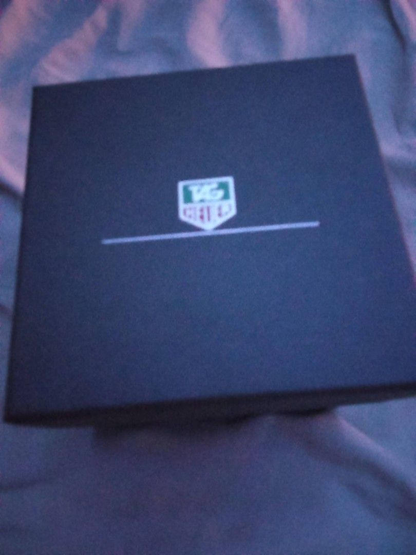 TAG Heuer Watch Box 2 boxes (Category: Accessory Holder, Box & Organizers) located in Caloocan City. Submitted by maynaito (Listing ID 1465308492, Image 1). Description: - Authentic TAG Heuer watch presentation box - Includes square outer box and round inner case - Features iconic green TAG Heuer shield logo on the lid - Clean dark interior finish with solid construction - Ideal replacement packaging or storage piece for collectors.