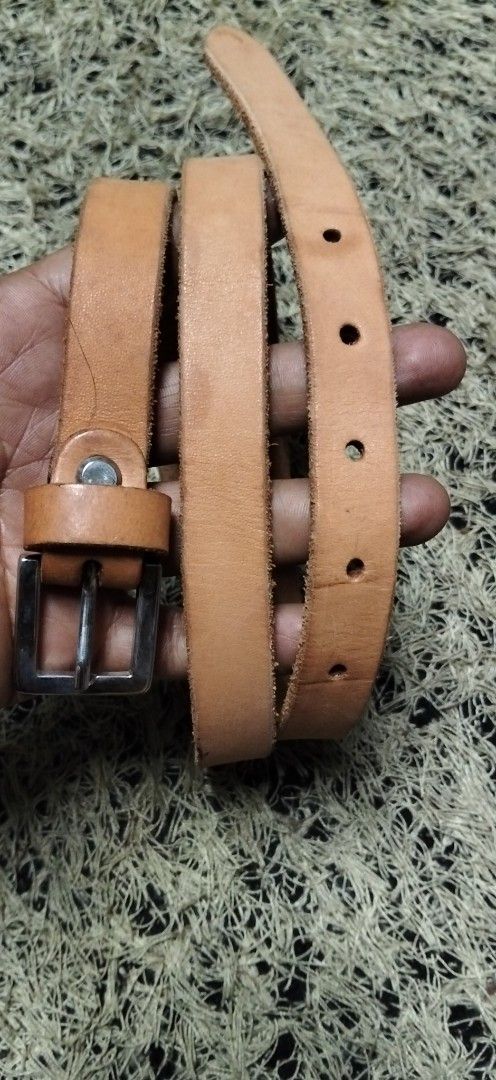 Tan brown leather belt with silver buckle (Category: Belts) located in Paranaque City. Submitted by michael-08 (Listing ID 1465263117, Image 1). Description: - Color: Tan brown - Hardware: Silver metal buckle and loop keeper - Design: Classic and simple with raw edges - Fit: Multiple punch holes for adjustable length - Versatility: Perfect for styling with both jeans and trousers PURE GENUINE LEATHER NO ISSUE LIKE A NEW CONDITION BODY WAISTLINE F