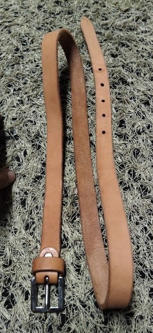 Tan brown leather belt with silver buckle (Category: Belts) located in Paranaque City. Submitted by michael-08 (Listing ID 1465263117, Image 3). Description: - Color: Tan brown - Hardware: Silver metal buckle and loop keeper - Design: Classic and simple with raw edges - Fit: Multiple punch holes for adjustable length - Versatility: Perfect for styling with both jeans and trousers PURE GENUINE LEATHER NO ISSUE LIKE A NEW CONDITION BODY WAISTLINE F