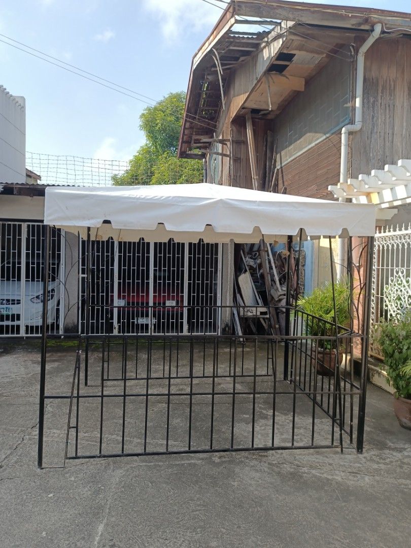 Tent (Category: Outdoor Furniture) located in Binan City. Submitted by thrifty.08 (Listing ID 1465200602, Image 3). Description: - Durable black metal and iron frame - White canvas top canopy for shade and shelter - Features built-in railings on 3 sides with an open front entry - Standard tent size, ideal for backyard patios and outdoor events - Pickup or delivery arrangement available.