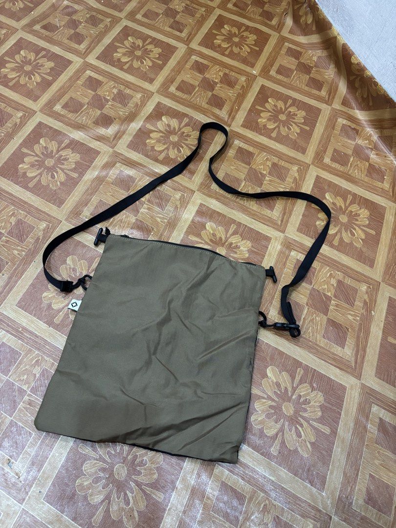 TERG Nylon/Poly Crossbody Bag (Category: Sling Bags) located in Manila. Submitted by noribrahim.20 (Listing ID 1465273846, Image 2). Description: - Brand: TERG - Material: Durable nylon and poly blend - Color: Khaki and black - Compartment: Secure zippered main compartment with internal brand tag - Pocket: Convenient front mesh pocket section - Strap: Adjustable black shoulder strap for custom fit - Use: Compact and stylish everyday carry -ISSUE 