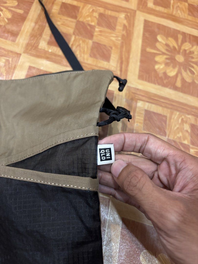 TERG Nylon/Poly Crossbody Bag (Category: Sling Bags) located in Manila. Submitted by noribrahim.20 (Listing ID 1465273846, Image 3). Description: - Brand: TERG - Material: Durable nylon and poly blend - Color: Khaki and black - Compartment: Secure zippered main compartment with internal brand tag - Pocket: Convenient front mesh pocket section - Strap: Adjustable black shoulder strap for custom fit - Use: Compact and stylish everyday carry -ISSUE 