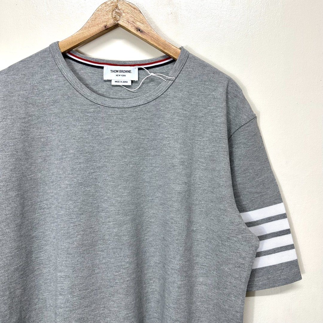 Thom Browne 4-Bar Stripe T-shirt (Category: Tshirts & Polo Shirts ) located in Manila. Submitted by dane.closet (Listing ID 1465341815, Image 1). Description: Thom Browne 4-Bar Stripe T-shirt Size: 3 Large fitting Dimension: 23x28-29 Brand new No flaws at all Authentic/Original Price: 5000 negotiable ✔️COD via Lalamove ✔️Door to door delivery via J&T express ✔️Open for meetups around Makati Area Dm me 💯.