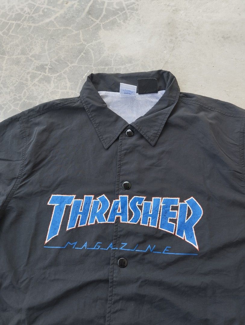 Thrasher x Champion Black Coaches Jacket Medium (Category: Coats, Jackets and Outerwear) located in Mati. Submitted by old_era.ph (Listing ID 1465171859, Image 2). Description: - Brand: Thrasher Magazine x Champion Collaboration - Item: Coaches Jacket - Color: Black with bold blue embroidered chest logo - Size: Medium - Details: Champion 'C' patch on left sleeve, snap button closure, standard collar, white mesh lining - Material: 100% nylon shell