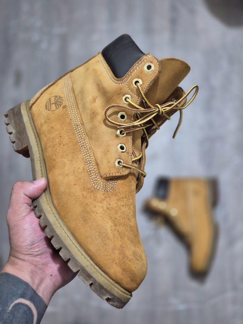 Timberland Premium Waterproof Boots Wheat Nubuck (Category: Boots) located in Manila. Submitted by kushoenero (Listing ID 1465301276, Image 1). Description: - Brand: Timberland - Material: Classic wheat nubuck leather upper - Details: Signature black padded leather collar, rustproof eyelets, and brown/yellow taslan laces - Sole: Durable lugged rubber outsole - Condition: Noticeable spotting and wear marks across the toe boxes and upper leather fr