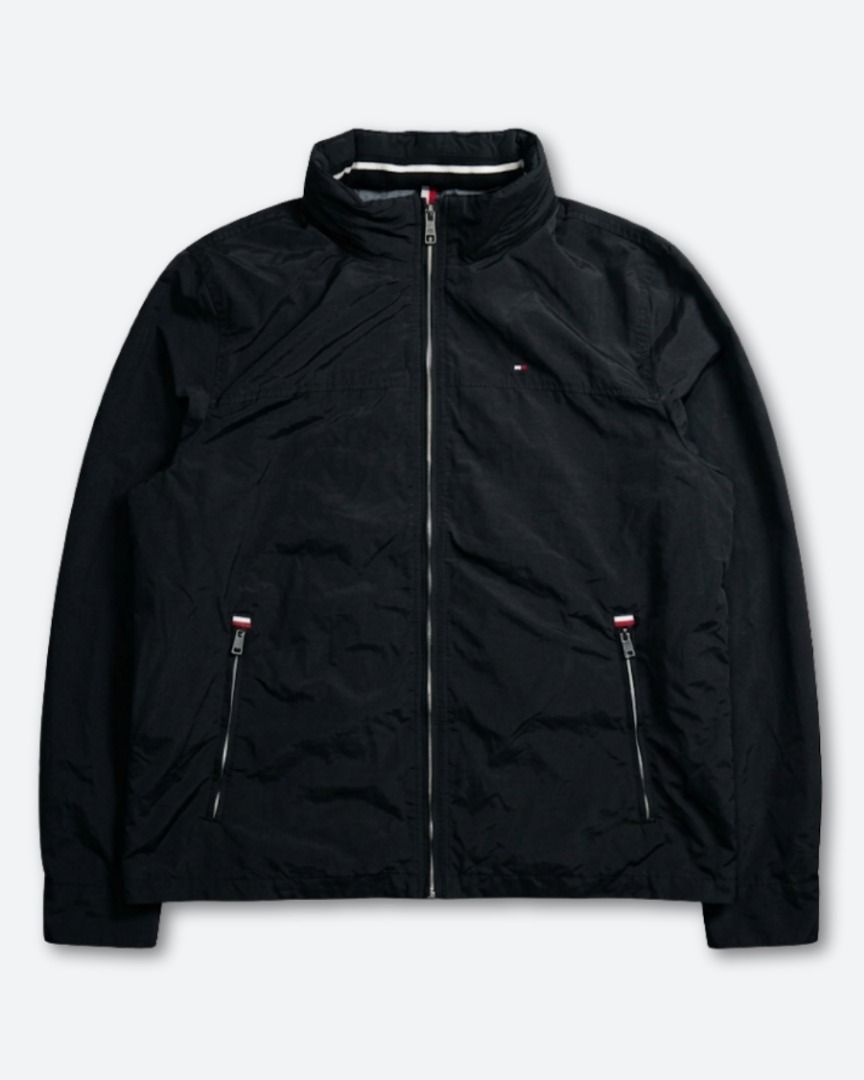 Tommy Hilfiger Black Sailing Jacket W/ Packable Hood (Category: Coats, Jackets and Outerwear) located in Baguio. Submitted by marcusmartin2600 (Listing ID 1465186110, Image 1). Description: Size: XL on tag Condition: Very good | signs of usage | white on the back can be washed | print fade 📏 Measurement via Tape Measure (in inches): Width: 26” Length: 28” Shoulders: 20” Sleeve Length: 27.5” Hem: 23.5” . Note: Please check detailed photos before 