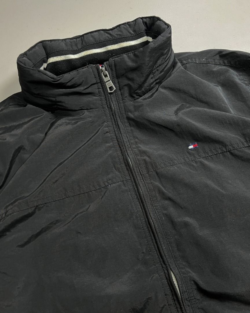 Tommy Hilfiger Black Sailing Jacket W/ Packable Hood (Category: Coats, Jackets and Outerwear) located in Baguio. Submitted by marcusmartin2600 (Listing ID 1465186110, Image 2). Description: Size: XL on tag Condition: Very good | signs of usage | white on the back can be washed | print fade 📏 Measurement via Tape Measure (in inches): Width: 26” Length: 28” Shoulders: 20” Sleeve Length: 27.5” Hem: 23.5” . Note: Please check detailed photos before 