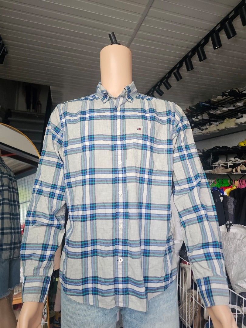 Tommy Hilfiger long-sleeve button-down shirt (Category: Formal Shirts) located in Baguio. Submitted by kayeonlineshop (Listing ID 1465225342, Image 2). Description: -Tommy Hilfiger long-sleeve button-down shirt featuring a light grey, blue, and teal plaid check pattern with a small chest pocket logo detail..