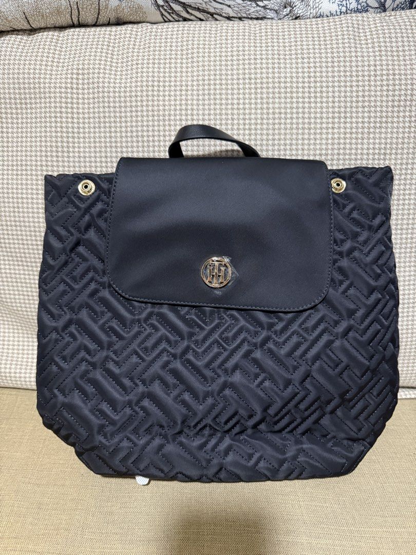 Tommy Hilfiger Monogram Quilted Black Backpack (Category: Backpacks) located in Quezon City. Submitted by gel.cortez (Listing ID 1465218137, Image 1). Description: Black Tommy Hilfiger backpack with quilted monogram pattern all over. Flap top closure with gold-toned TH logo hardware on the front. Adjustable black shoulder straps and top grab handle. Still has the original store tag attached to the back. Clean condition, zero flaws..