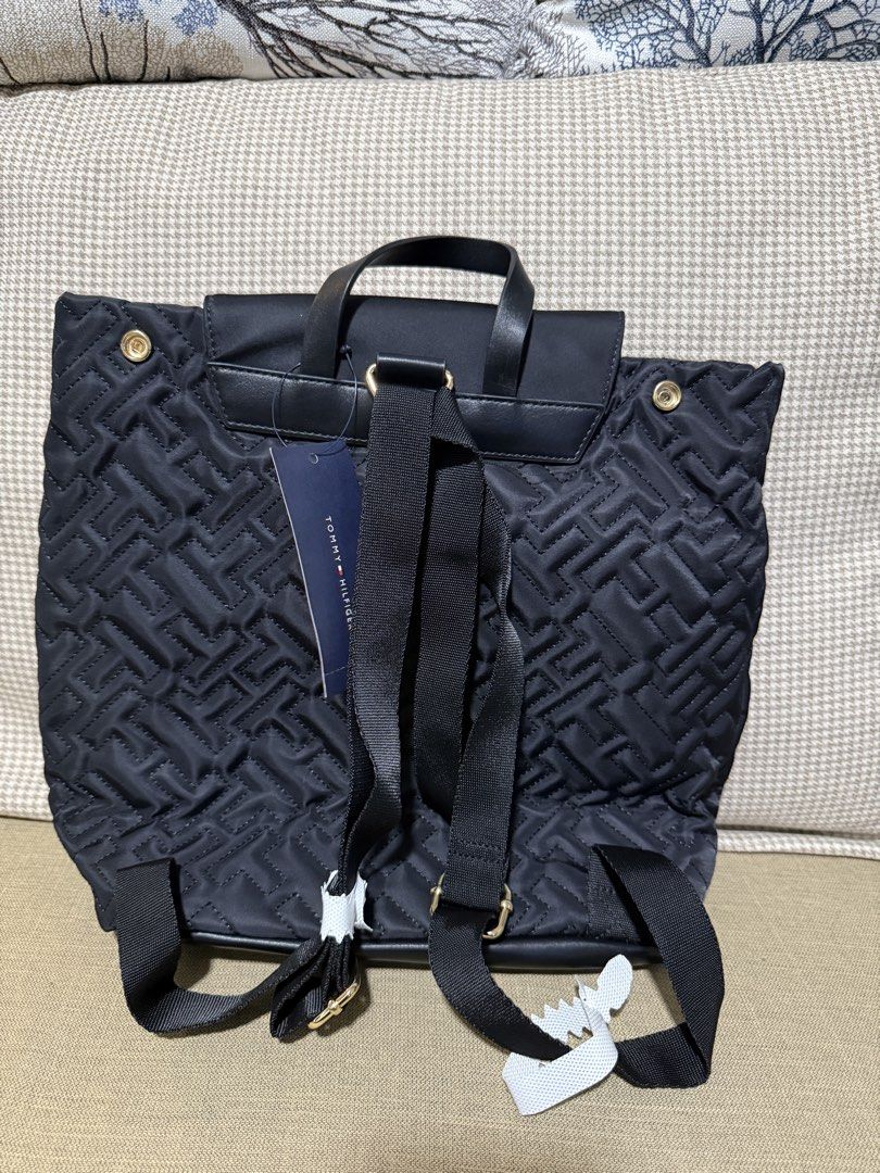 Tommy Hilfiger Monogram Quilted Black Backpack (Category: Backpacks) located in Quezon City. Submitted by gel.cortez (Listing ID 1465218137, Image 2). Description: Black Tommy Hilfiger backpack with quilted monogram pattern all over. Flap top closure with gold-toned TH logo hardware on the front. Adjustable black shoulder straps and top grab handle. Still has the original store tag attached to the back. Clean condition, zero flaws..