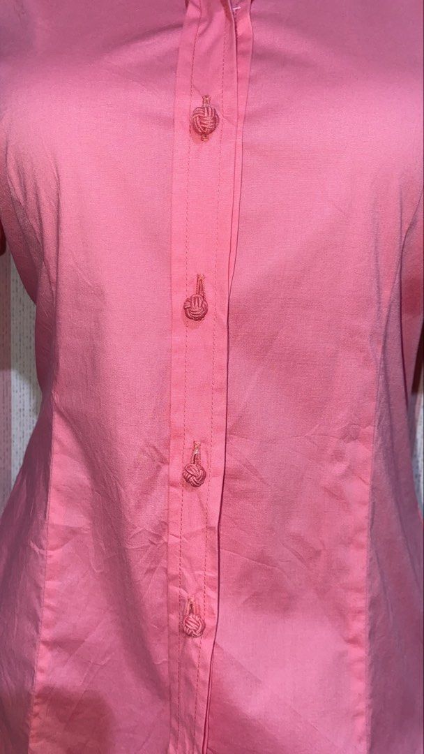 Tommy Hilfiger Pink Button-Down Short Sleeve polo (Category: Shirts) located in President Roxas. Submitted by starksandmoon_ii (Listing ID 1465181767, Image 3). Description: - Brand: Tommy Hilfiger - Color: Pink - Size: 8 - Style: Short sleeve button-down with folded cuffs and structured waist darts - Details: Unique knot buttons and subtle logo tag near the hem - Condition: Clean and ready to wear.