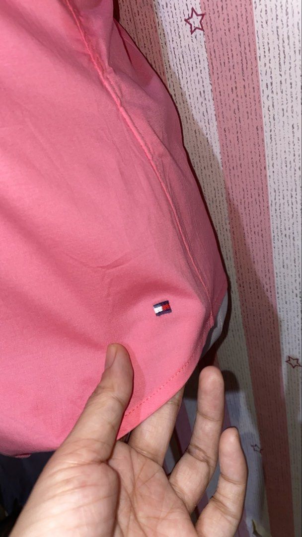 Tommy Hilfiger Pink Button-Down Short Sleeve polo (Category: Shirts) located in President Roxas. Submitted by starksandmoon_ii (Listing ID 1465181767, Image 2). Description: - Brand: Tommy Hilfiger - Color: Pink - Size: 8 - Style: Short sleeve button-down with folded cuffs and structured waist darts - Details: Unique knot buttons and subtle logo tag near the hem - Condition: Clean and ready to wear.