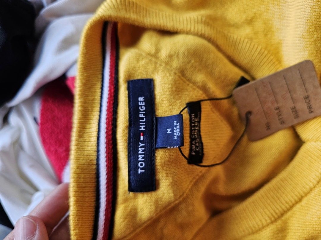 Tommy Hilfiger V-neck Sweater (Category: Coats, Jackets and Outerwear) located in Baguio. Submitted by kayeonlineshop (Listing ID 1465251381, Image 3). Description: -bright mustard-yellow V-neck sweater from Tommy Hilfiger features a classic ribbed hem and the brand's iconic embroidered flag logo on the chest..
