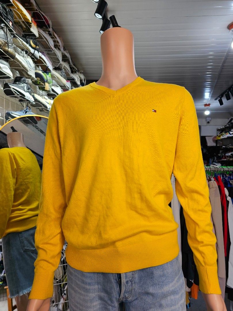 Tommy Hilfiger V-neck Sweater (Category: Coats, Jackets and Outerwear) located in Baguio. Submitted by kayeonlineshop (Listing ID 1465251381, Image 2). Description: -bright mustard-yellow V-neck sweater from Tommy Hilfiger features a classic ribbed hem and the brand's iconic embroidered flag logo on the chest..