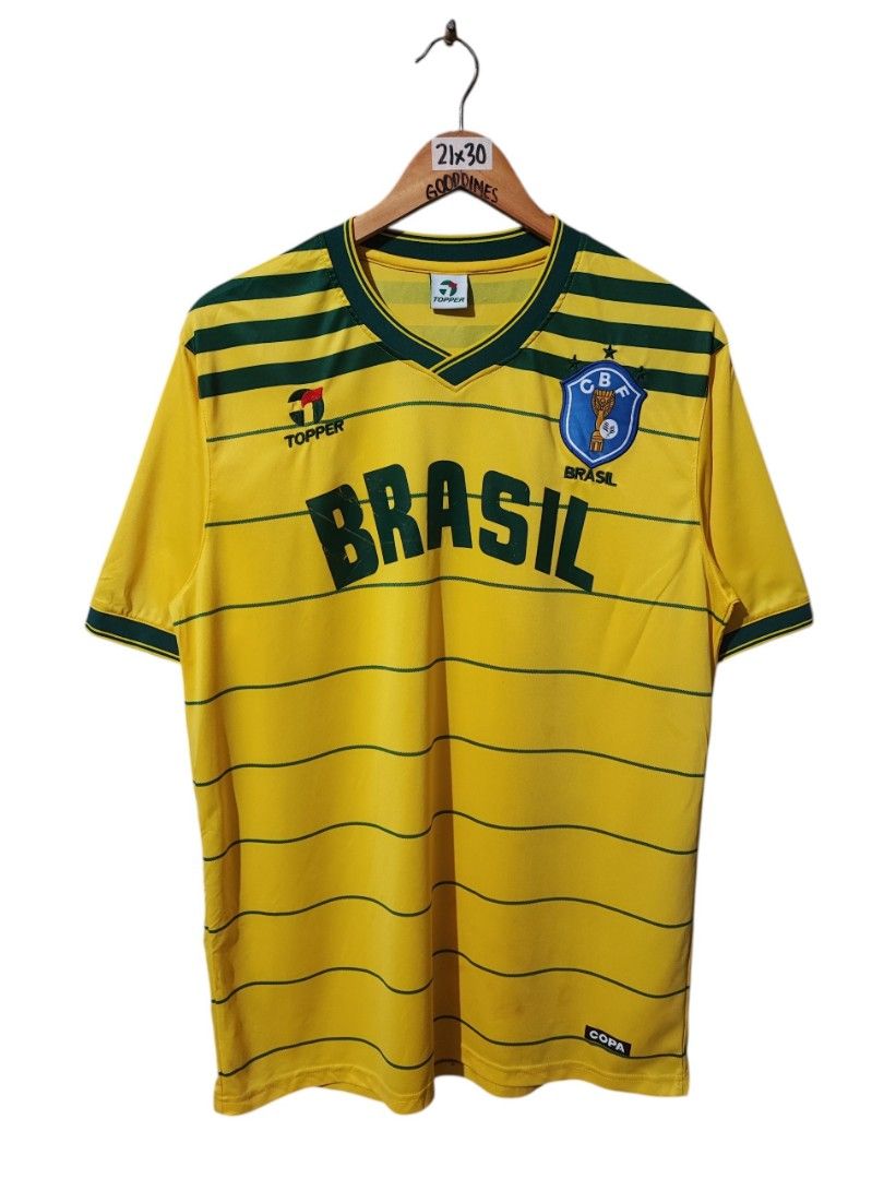 TOPPER BRAZIL 1984 HOME JERSEY (Category: Activewear) located in Iloilo. Submitted by gooddimes (Listing ID 1465290325, Image 1). Description: Topper Brazil 1984 Home Jersey Embroidered Topper Logo Patch CBF Brazil Logo Size on tag: Large Dimes: 21Wx30L Issue/s: Minimal print transfer and minimal hairlines Color rate: 10/10 Still in Excellent condition ₱850 Reminders: - All items are thrifted, please manage your expectations - Color may vary due 