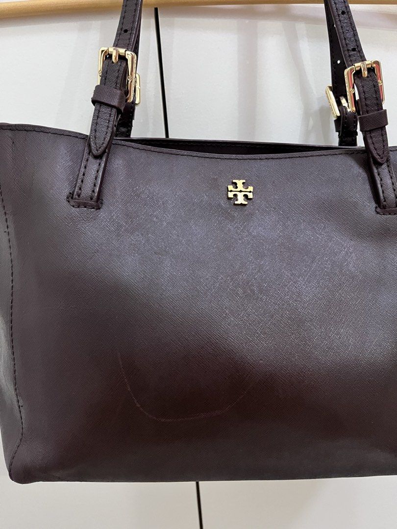 Tory Burch Dark Brown Leather Tote Bag (Category: Tote Bags) located in Cavite. Submitted by vanity_isme (Listing ID 1465338853, Image 3). Description: - Tory Burch Dark Brown Shoulder Bag - Hardware: Gold accents - Interior: Spacious with multiple compartments, zip pocket, and patterned fabric lining - Straps: Adjustable shoulder straps - Condition: Structured shape with minor scuff marks on the front and side exterior panels; clean interior lin