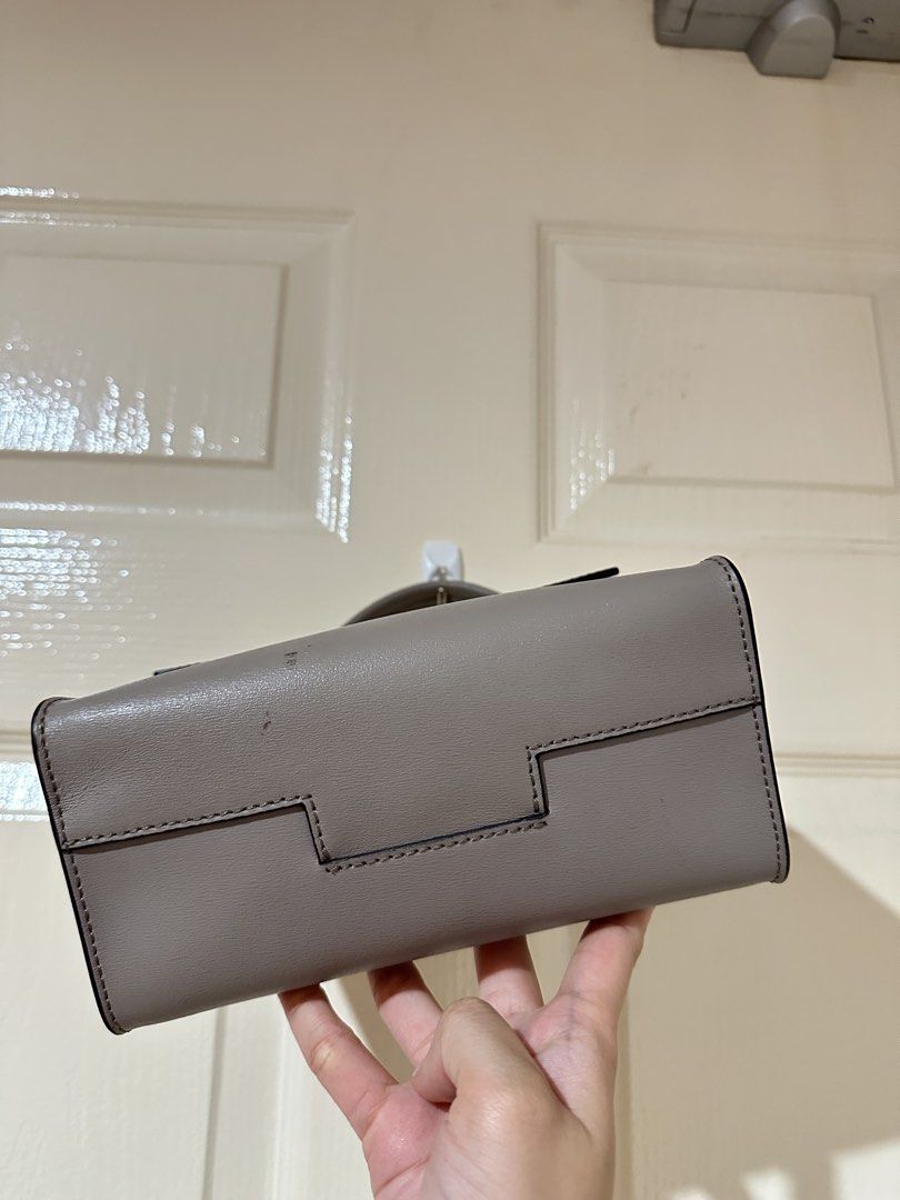 Tory Burch grey leather top handle bag (Category: Luxury Bags & Wallets) located in Manila. Submitted by ktyyycloset (Listing ID 1465333046, Image 2). Description: - Brand: Tory Burch - Color: Classic Neutral Grey - Material: Premium Leather - Style: Structured top handle bag with front flap closure and silver-tone hardware - Perfect for daily outfits and effortless styling -check photos for the condition -with long strap (good condition) .
