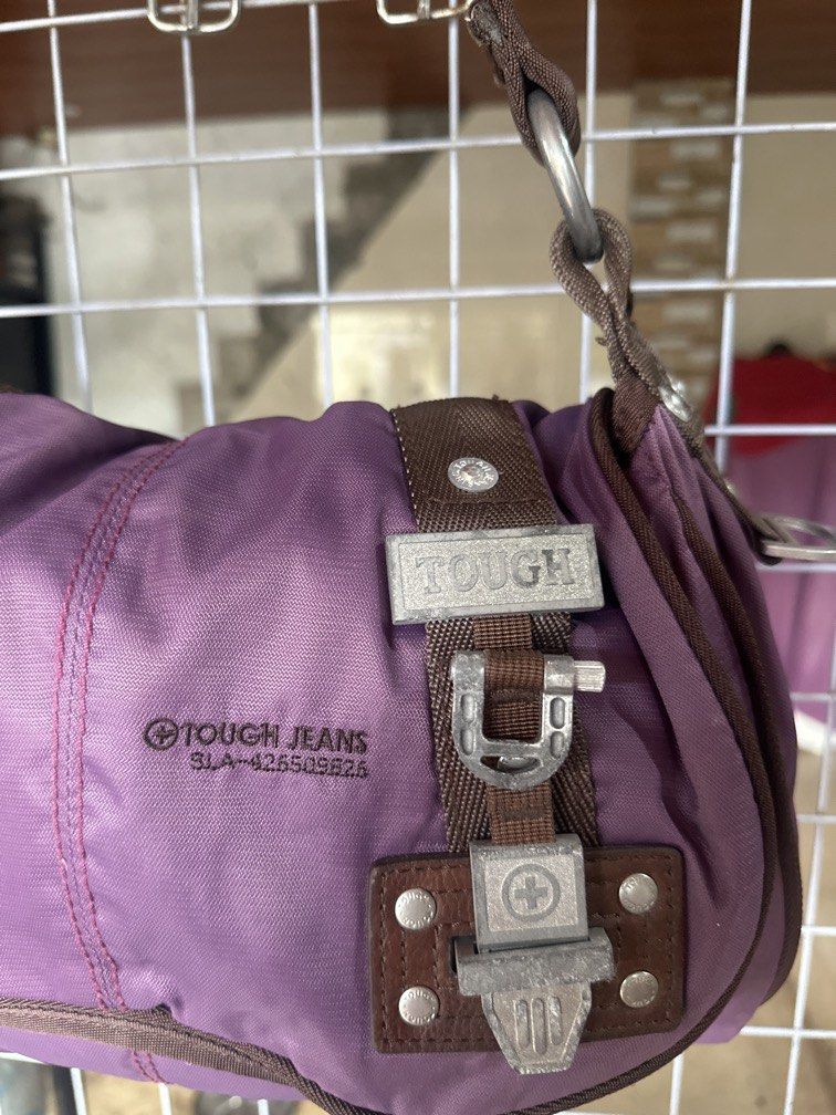 Tough shoulder bag purple nylon (Category: Shoulder Bags) located in Caloocan City. Submitted by hariel_beverly_onlineshop (Listing ID 1465226740, Image 2). Description: This is a purple nylon shoulder bag from TOUGH Jeansmith featuring brown trim and distinctive metallic buckle details. Location north caloocan.