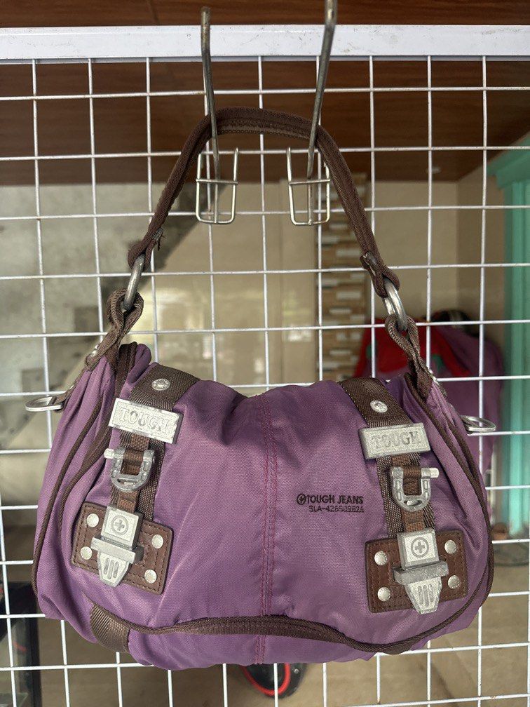 Tough shoulder bag purple nylon (Category: Shoulder Bags) located in Caloocan City. Submitted by hariel_beverly_onlineshop (Listing ID 1465226740, Image 1). Description: This is a purple nylon shoulder bag from TOUGH Jeansmith featuring brown trim and distinctive metallic buckle details. Location north caloocan.