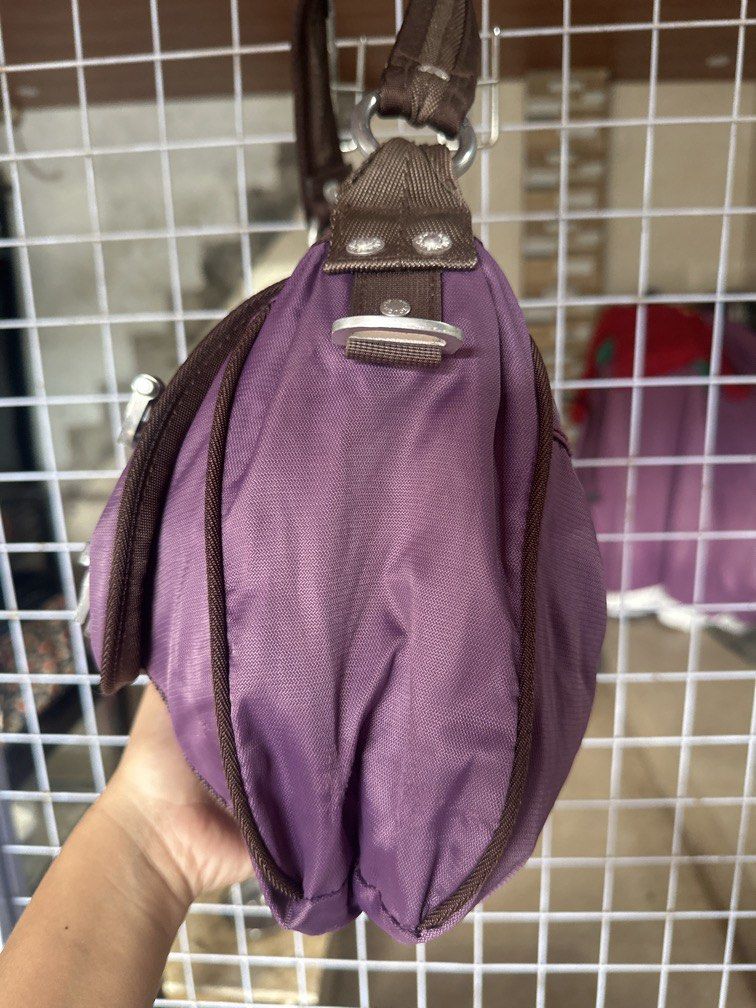 Tough shoulder bag purple nylon (Category: Shoulder Bags) located in Caloocan City. Submitted by hariel_beverly_onlineshop (Listing ID 1465226740, Image 3). Description: This is a purple nylon shoulder bag from TOUGH Jeansmith featuring brown trim and distinctive metallic buckle details. Location north caloocan.