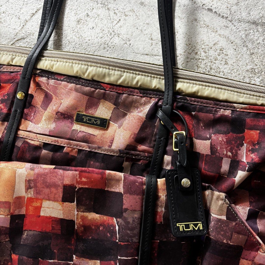 Tumi Voyageur Q-Tote in a multi-color patchwork mosaic (Category: Luxury Bags & Wallets) located in Caloocan City. Submitted by thrift.crcl (Listing ID 1465331521, Image 2). Description: Tumi Voyageur Q-Tote in a multi-color patchwork mosaic Good condition Fix price Size medium .