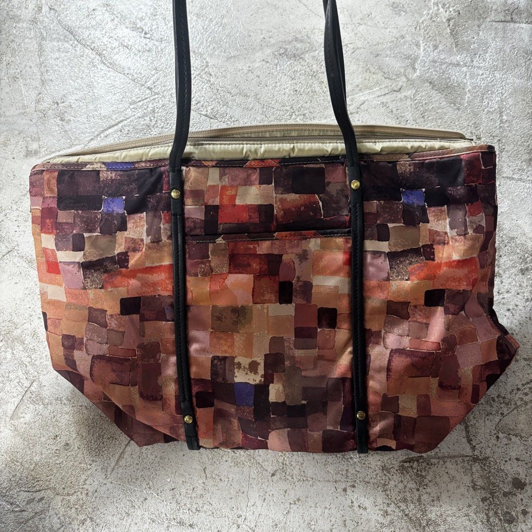 Tumi Voyageur Q-Tote in a multi-color patchwork mosaic (Category: Luxury Bags & Wallets) located in Caloocan City. Submitted by thrift.crcl (Listing ID 1465331521, Image 3). Description: Tumi Voyageur Q-Tote in a multi-color patchwork mosaic Good condition Fix price Size medium .