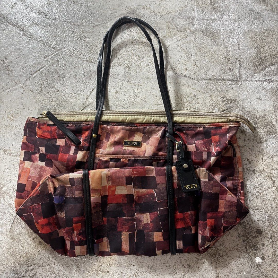 Tumi Voyageur Q-Tote in a multi-color patchwork mosaic (Category: Luxury Bags & Wallets) located in Caloocan City. Submitted by thrift.crcl (Listing ID 1465331521, Image 1). Description: Tumi Voyageur Q-Tote in a multi-color patchwork mosaic Good condition Fix price Size medium .