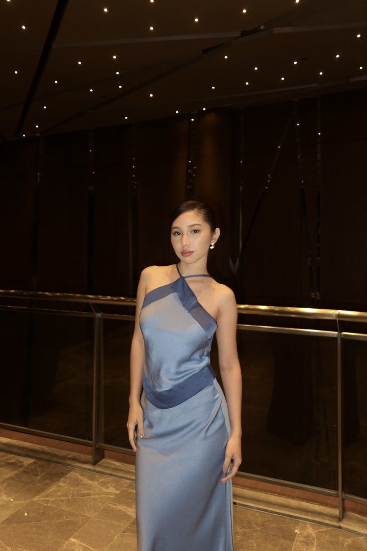 Two-Tone Halter Neck Dress with Adjustable Straps (Category: Dresses) located in Manila. Submitted by jhoysfabcloset (Listing ID 1465237995, Image 2). Description: - Style: Two-tone halter midi dress in grey and dark grey - Finish: Smooth satin with a subtle sheen - Design: Diamond-shaped front panel with contrast piping - Fit: Adjustable shoulder straps with metal sliders and hidden back zipper - Length: Elegant midi silhouette.