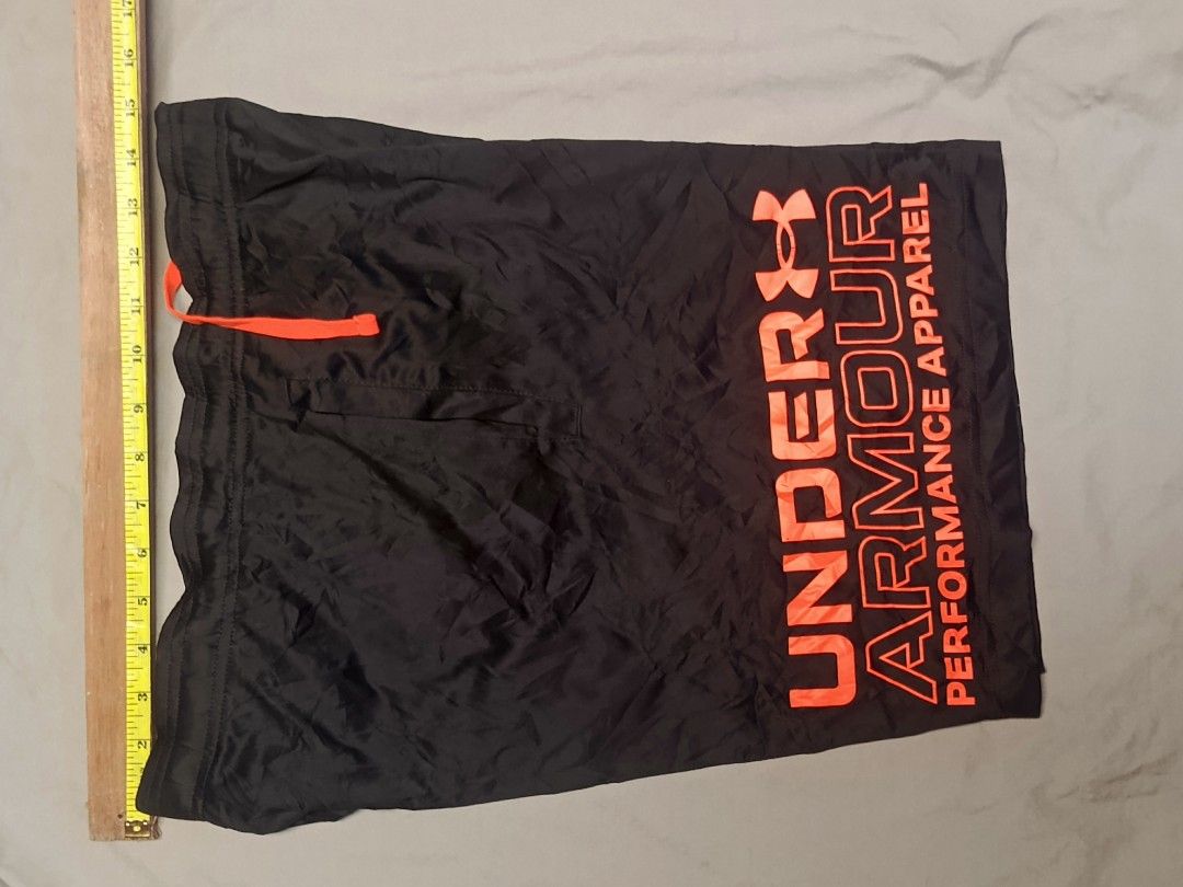 Under Armour Performance Apparel Black Shorts Size S (Category: Shorts) located in City of Isabela. Submitted by warmbird.d06e6f (Listing ID 1465224145, Image 3). Description: - Brand: Under Armour Performance Apparel - Style: Loose fit athletic shorts - Size: Small - Color: Black with bright orange drawstring and matching leg logo - Condition/Origin: Made in Vietnam - Measurements: ~15 inches across waist (laid flat), ~16 inches total length - I