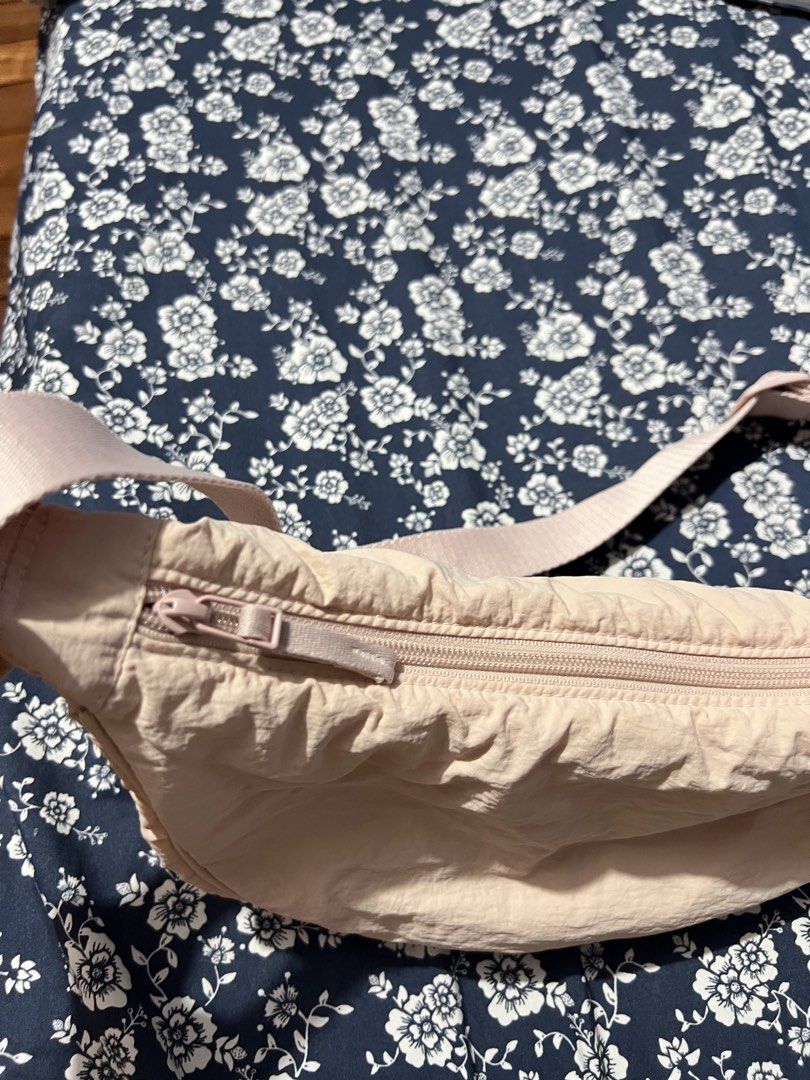 Uniqlo Round Mini Shoulder Bag Light Pink (Category: Cross-body Bags) located in Manila. Submitted by colesj (Listing ID 1465172543, Image 3). Description: - Brand: Uniqlo Round Mini Shoulder Bag - Color: Light Pink - Material: Durable and lightweight nylon - Features: Adjustable strap, smooth zipper closure, and convenient interior pocket - Condition Note: Inside pocket has a few minor ink stains near the bottom lining (does not affect outer app