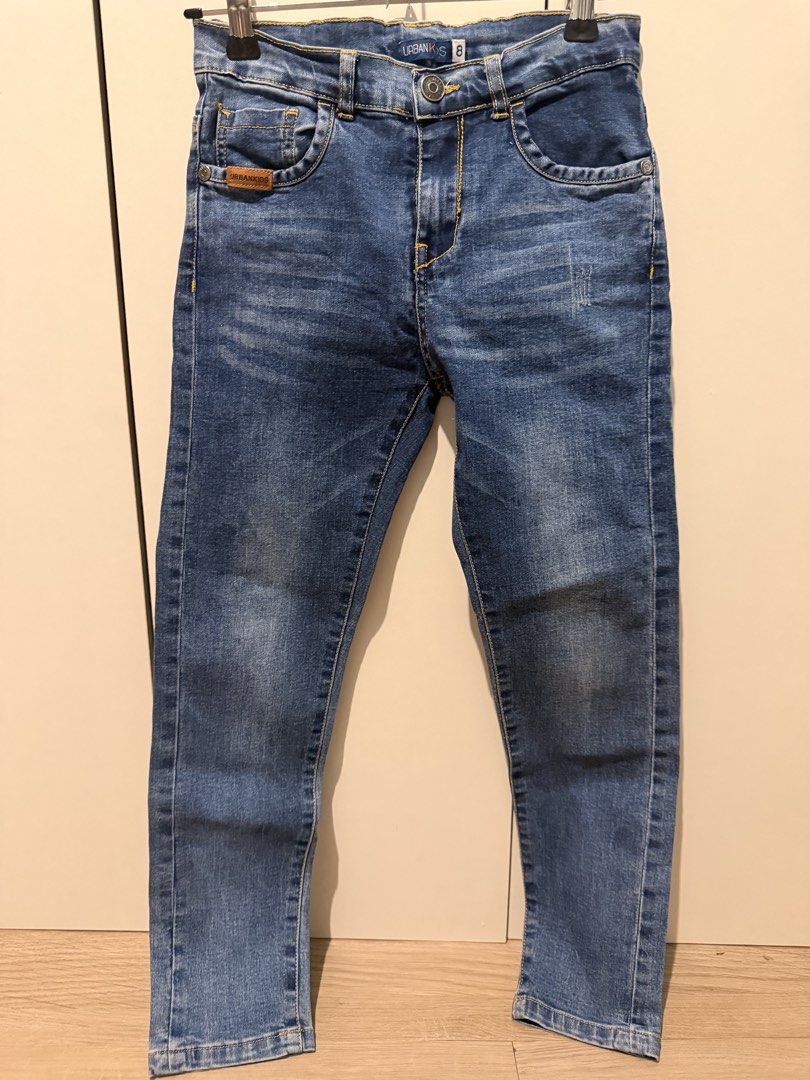 URBANKIDS Blue Denim Jeans Size 8 (Category: Babies & Kids Fashion) located in Las Pinas. Submitted by kleoshop24 (Listing ID 1465211974, Image 1). Description: - Brand: Urbankids - Size: 8 (Tag attached inside waistband) - Color: Classic blue denim with standard washing effect - Fit: Straight leg cut - Details: Button closure with zipper fly, classic 5-pocket layout, contrast yellow stitching, and small leather patch on the front pocket - Condit