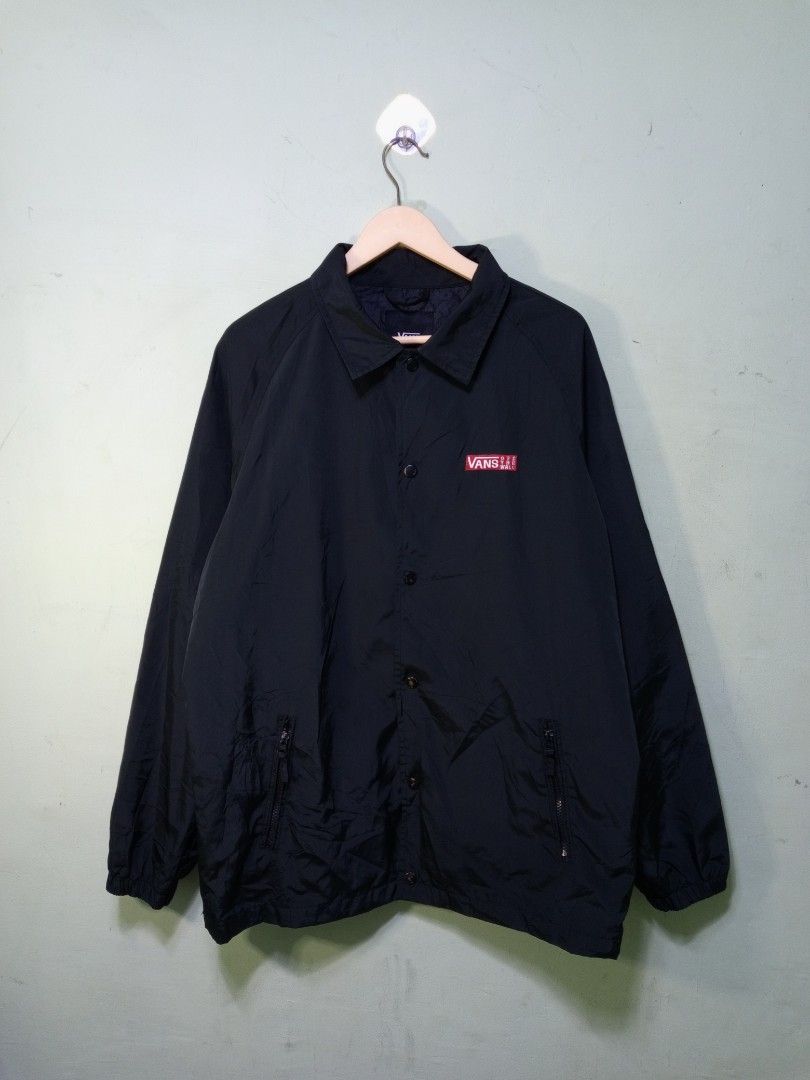 Vans Black Coach Jacket With Big Back Logo (Category: Coats, Jackets and Outerwear) located in Manila. Submitted by onewikstraight (Listing ID 1465362718, Image 1). Description: - Brand: Vans - Item: Coach Jacket - Color: Black with pink and white back graphic - Features: Button-down front, secure zippered side pockets, classic collar, and elastic cuffs - Details: Small embroidered Vans chest logo and large 'Off The Wall' box graphic on the back 