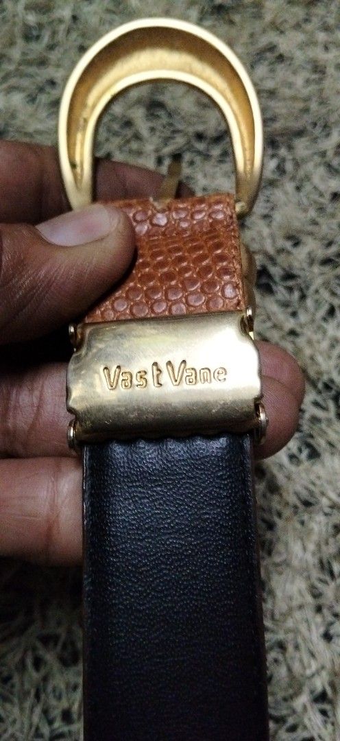 Vast Vane Textured Brown Belt with Gold Hardware (Category: Belts) located in Paranaque City. Submitted by michael-08 (Listing ID 1465252149, Image 2). Description: - Brand: Vast Vane - Color: Brown with black interior lining - Material/Texture: Textured finish - Hardware: Matte gold buckle and double keeper loops - Details: Signature logo stamped near the tail end with standard hole adjustments - Style: Perfect for casual or smart-casual outfits