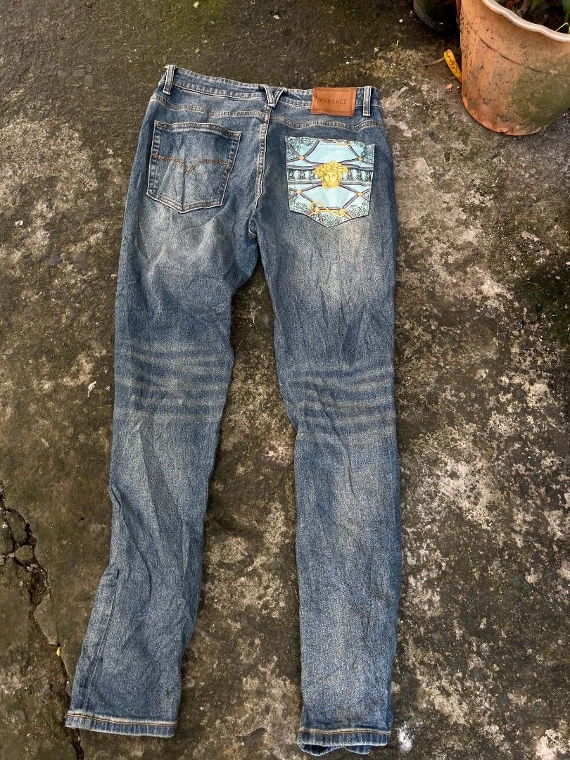 Versace Jeans Blue Denim Size 32 (Category: Jeans) located in Manila. Submitted by sls.wear (Listing ID 1465208157, Image 2). Description: - Brand: Versace - Style: Denim jeans in a versatile medium wash blue - Size: 32 (tag inside) - Origin: Made in Italy - Hardware: Signature Versace engraved on button and rivets; smooth YKK zipper - Details: Eye-catching bright blue and gold Medusa head patterned design on one back pocket - Branding: Genuine l