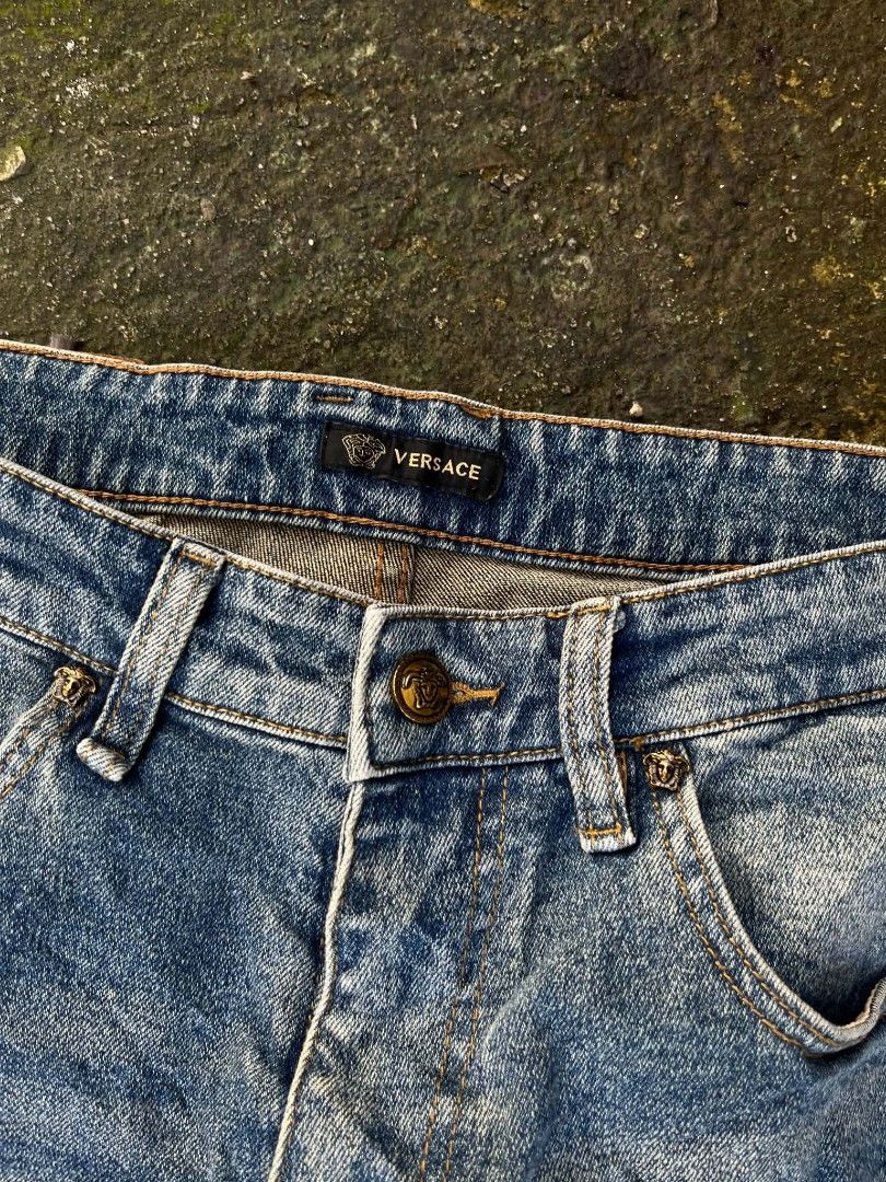 Versace Jeans Blue Denim Size 32 (Category: Jeans) located in Manila. Submitted by sls.wear (Listing ID 1465208157, Image 3). Description: - Brand: Versace - Style: Denim jeans in a versatile medium wash blue - Size: 32 (tag inside) - Origin: Made in Italy - Hardware: Signature Versace engraved on button and rivets; smooth YKK zipper - Details: Eye-catching bright blue and gold Medusa head patterned design on one back pocket - Branding: Genuine l