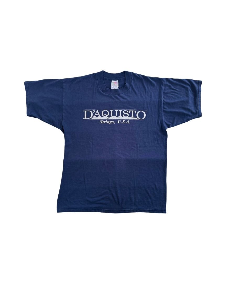 Vintage 1990s D'AQUISTO STRINGS USA (Category: Shirts) located in Cebu City. Submitted by threadless.vtg (Listing ID 1465329971, Image 3). Description: Vintage 1990s D'AQUISTO STRINGS, USA Tag: Fruit of the Loom Size: L Color: Navy Blue (color may vary due to lighting) Condition: Good Measurements: 20.5" W × 26.5" L Issue: Tag has frayed edges + slight pilling around neckline PHP 280 🚚 Free nationwide shipping Bulk orders may require additional 
