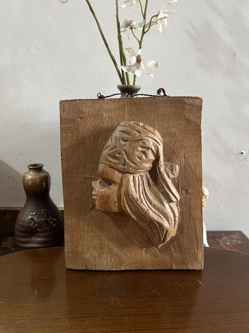 Vintage solid wood ,Hand-carve , native boy Profile Wall Plaque (Category: Wall Decor) located in Taguig. Submitted by minmin_parker (Listing ID 1465224631, Image 1). Description: - Unique hand-carved wooden wall plaque - Features a profile of a woman with textured hair and headdress details - Mounted on a sturdy rectangular wooden block - Comes with a hanging string attached at the top for easy display - Natural wood grain with warm brown tones 