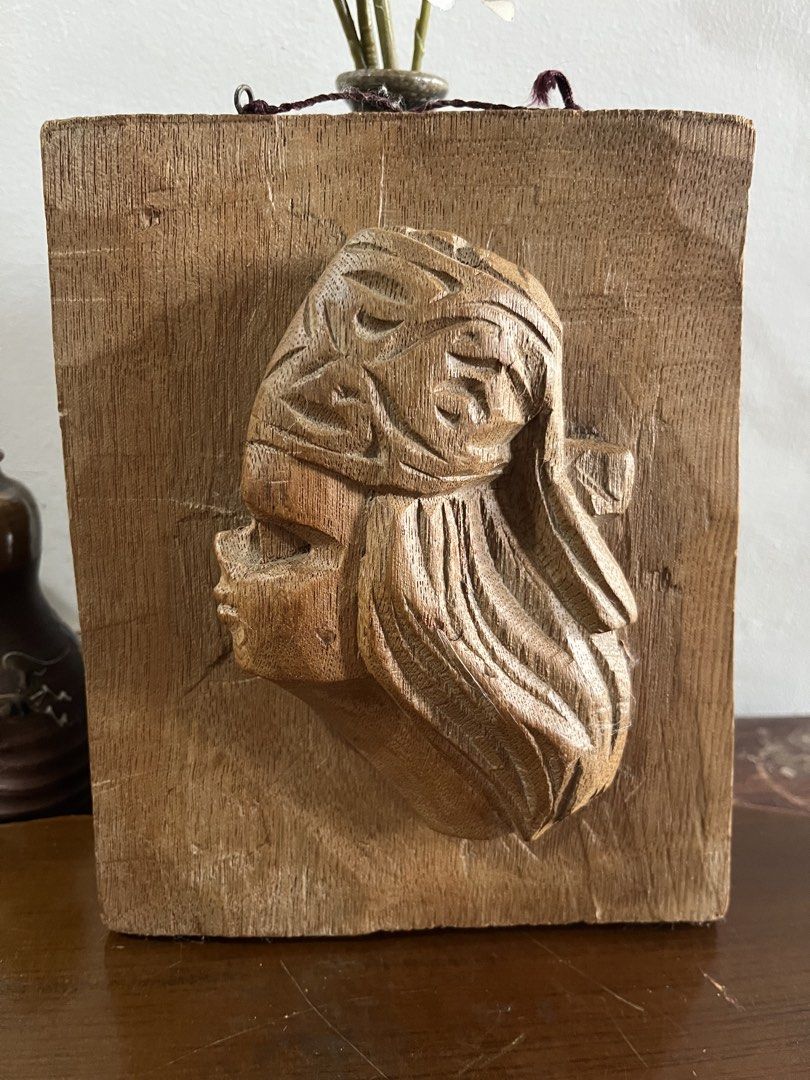 Vintage solid wood ,Hand-carve , native boy Profile Wall Plaque (Category: Wall Decor) located in Taguig. Submitted by minmin_parker (Listing ID 1465224631, Image 2). Description: - Unique hand-carved wooden wall plaque - Features a profile of a woman with textured hair and headdress details - Mounted on a sturdy rectangular wooden block - Comes with a hanging string attached at the top for easy display - Natural wood grain with warm brown tones 
