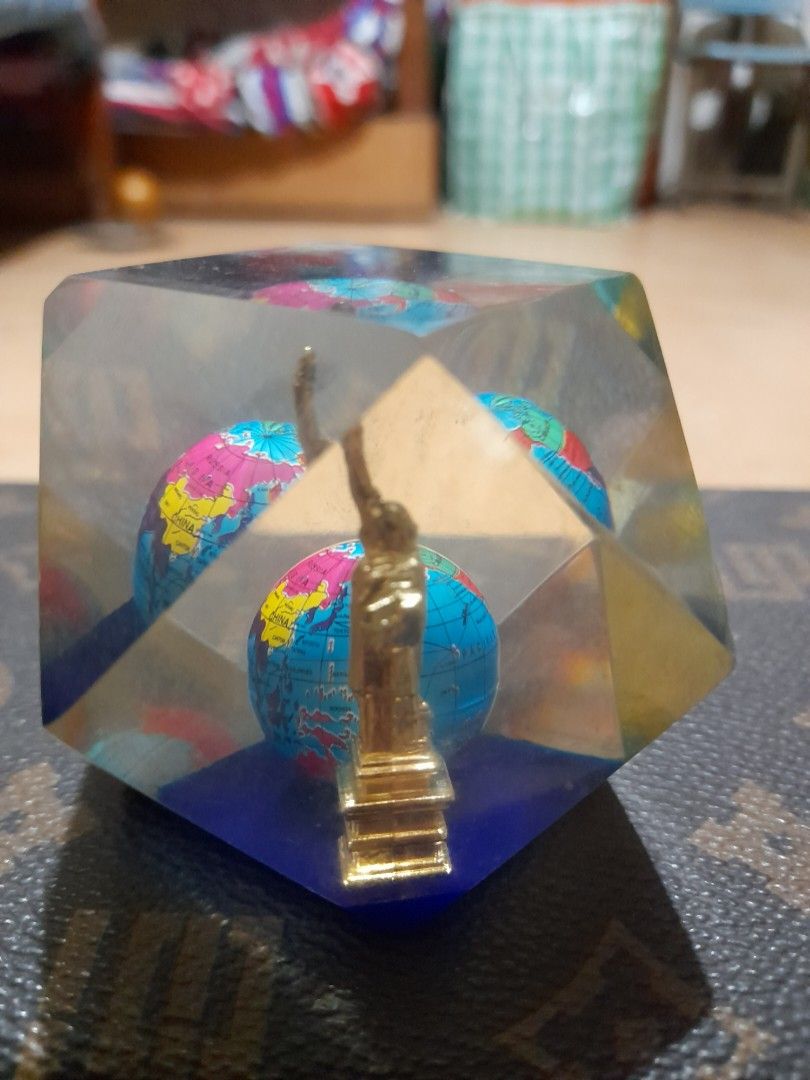Vintage Liberty Globe Table Decor / Paperweight (Category: Vintage Collectibles) located in Bocaue. Submitted by marajapansurplus (Listing ID 1465315291, Image 1). Description: - Material: Clear faceted resin with a heavy, flat-bottomed base - Design: Encloses a multi-colored mini globe and a golden monument figurine - Visuals: Geometric block reflects light from multiple angles - Condition: Excellent, no major surface scratches - Ideal Use: Grea