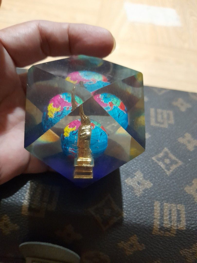 Vintage Liberty Globe Table Decor / Paperweight (Category: Vintage Collectibles) located in Bocaue. Submitted by marajapansurplus (Listing ID 1465315291, Image 2). Description: - Material: Clear faceted resin with a heavy, flat-bottomed base - Design: Encloses a multi-colored mini globe and a golden monument figurine - Visuals: Geometric block reflects light from multiple angles - Condition: Excellent, no major surface scratches - Ideal Use: Grea