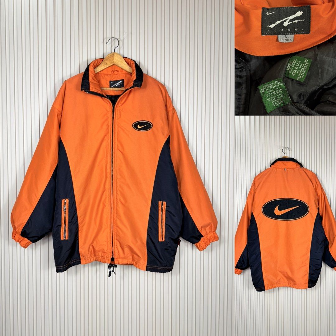 Vintage Nike Orange and Black Zip Jacket (Category: Coats, Jackets and Outerwear) located in Pasig City. Submitted by trendapparelph (Listing ID 1465256219, Image 1). Description: - Brand: Vintage Nike - Colorway: Orange and Black with contrast paneling - Fit: Oversized fit - Features: Full zip front, dual zipped side pockets, adjustable drawstring hem - Branding: Large embroidered Nike swoosh on the back, small swoosh on the chest - Sizing: Coll