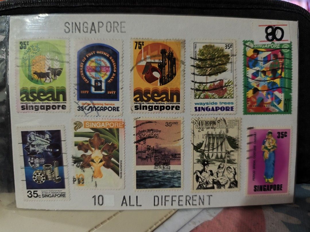 Vintage Postage Stamps Collection (Category: Stamps & Prints) located in Paranaque City. Submitted by heyitsmeaj (Listing ID 1465244304, Image 3). Description: - Collection of vintage postage stamps and souvenir items - Features Manama butterfly stamps, Ajman art stamp, Singapore commemorative sets, Romania Los Angeles 84 sports stamps, and a Sacred Heart souvenir album - Stored securely in protective sleeves - Perfect for stamp collectors and to