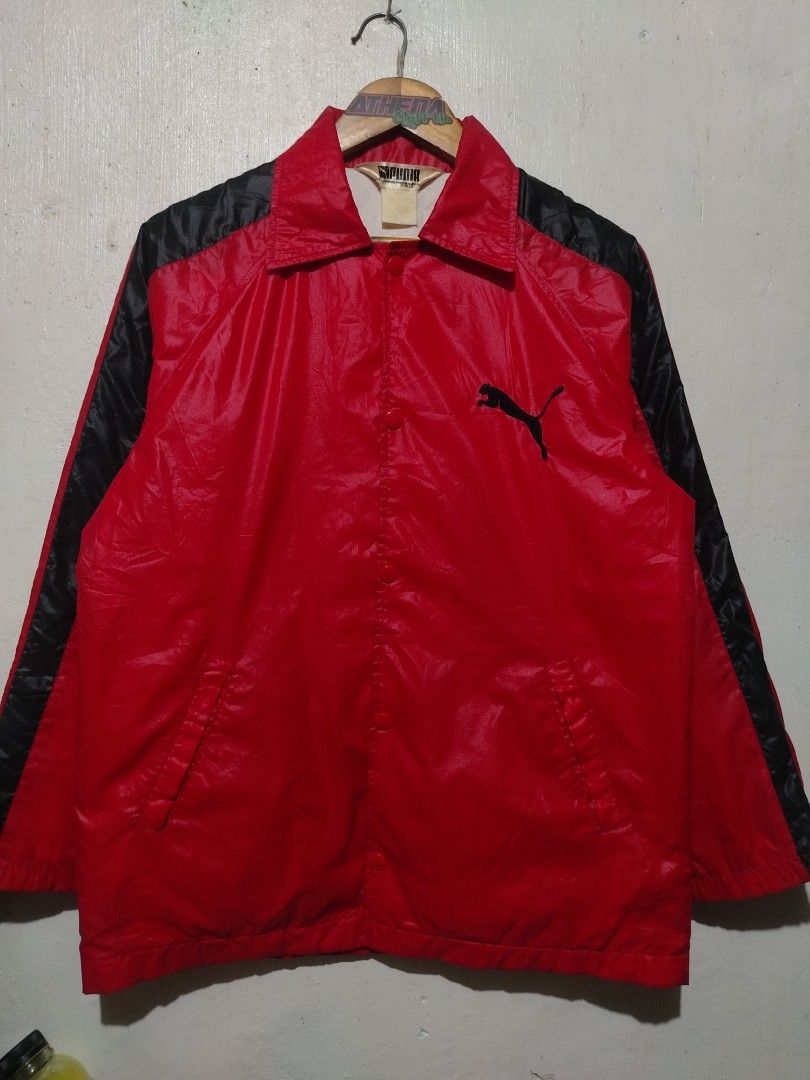 Vintage Puma Red Black Coach Jacket (Category: Coats, Jackets and Outerwear) located in Rizal. Submitted by gmpastoffi75031 (Listing ID 1465328009, Image 1). Description: - dimes 22x28.5 - Color: Red and black with white inner lining - Closure: Snap button front - Pockets: Convenient side pockets - Branding: Embroidered black Puma leaping cat logo on the chest - Details: Black stripes running down both sleeves and classic collar neckline - Style:
