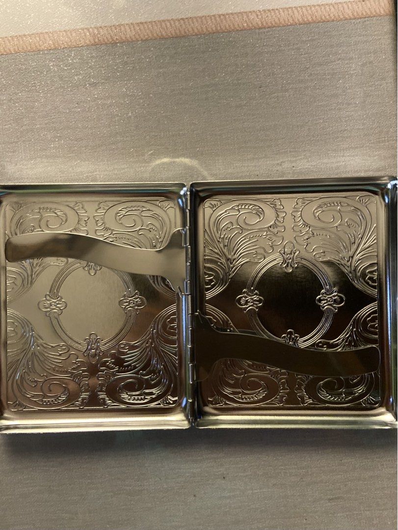Vintage silver engraved metal cigarette case/wallet (Category: Vintage Collectibles) located in Makati City. Submitted by ellope (Listing ID 1465338180, Image 2). Description: - Vintage silver metal cigarette case with detailed floral and scroll engravings - Dual compartments equipped with secure retention bars - Shiny polished finish on both exterior and interior surfaces - Compact rectangular design that fits easily into pockets or bags - Brand