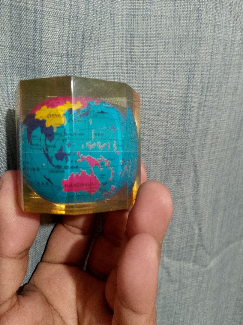Vintage world globe map (Category: Stationery & School Supplies) located in Taguig. Submitted by generygwap31973 (Listing ID 1465376130, Image 2). Description: Mini globe encased in a transparent yellow resin block. Multi-colored continents printed on the inner sphere. Heavy enough to hold down papers on a desk. Compact hexagonal shape with flat sides. Fun accessory for a study table or office desk. Interesting conversation piece for map enthusia
