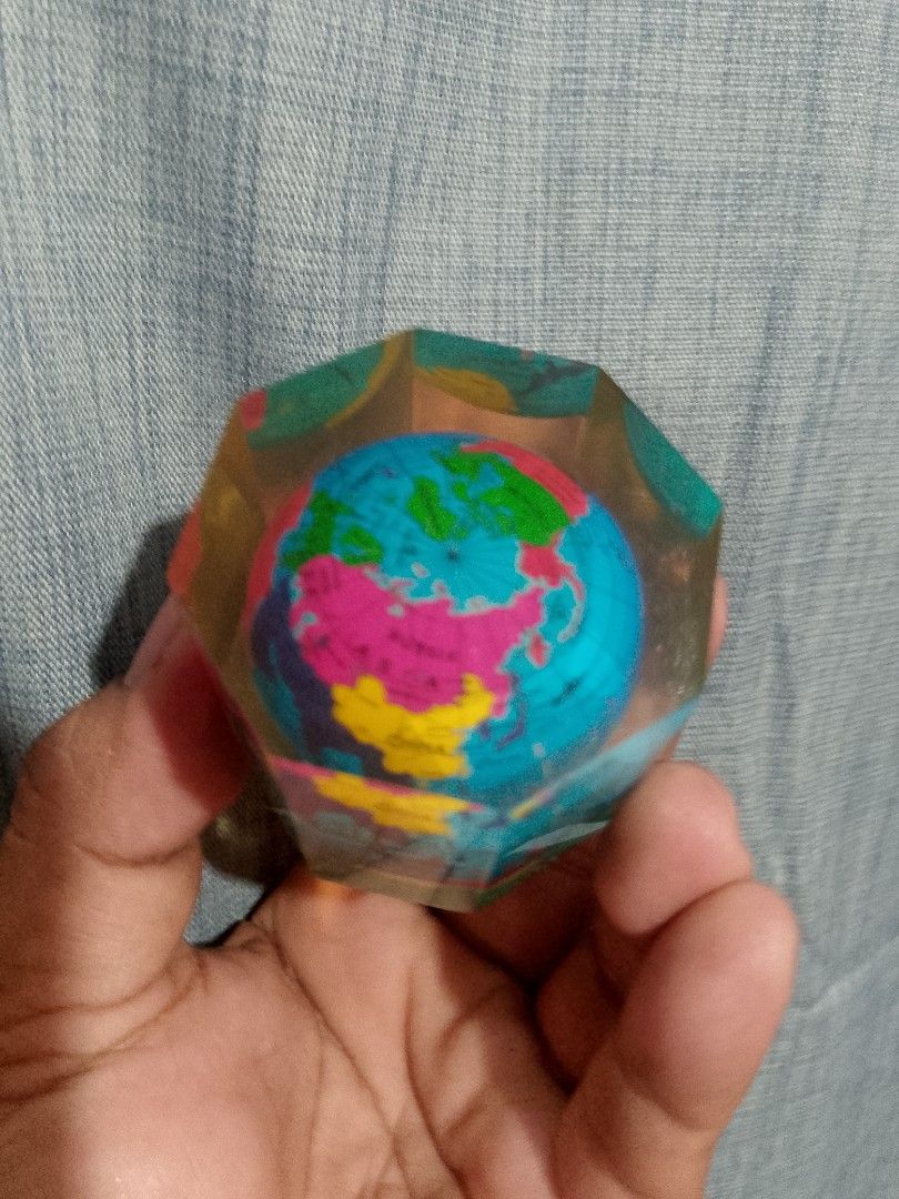Vintage world globe map (Category: Stationery & School Supplies) located in Taguig. Submitted by generygwap31973 (Listing ID 1465376130, Image 3). Description: Mini globe encased in a transparent yellow resin block. Multi-colored continents printed on the inner sphere. Heavy enough to hold down papers on a desk. Compact hexagonal shape with flat sides. Fun accessory for a study table or office desk. Interesting conversation piece for map enthusia