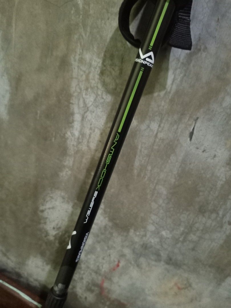 Visionpeaks Antishock System Trekking Pole Hiking Stick (Category: Hiking & Camping) located in Tagum. Submitted by its_yoboii (Listing ID 1465210677, Image 3). Description: - Brand/Model: Visionpeaks trekking pole - Color: Black and green design - Features: Anti-shock system, ergonomic grip handle, and adjustable wrist strap - Mechanism: Twist-lock height adjustment on the shaft - Ideal for: Hiking, camping, and outdoor trail walking.